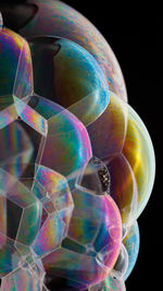 Close-up of bubbles over black background