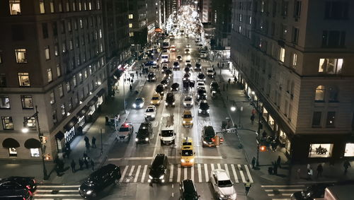 High angle view of traffic on city street and buildings at night, manhattan,usa