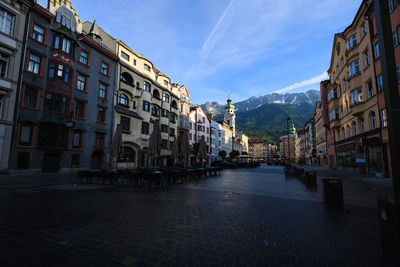 Street amidst buildings in town against sky