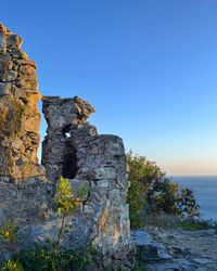 Low angle view of rock formation against clear sky