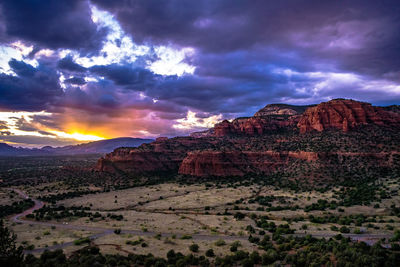 View of desert against cloudy sky