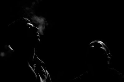 Close-up of two women against black background