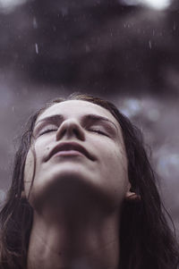 Close-up of young woman looking up