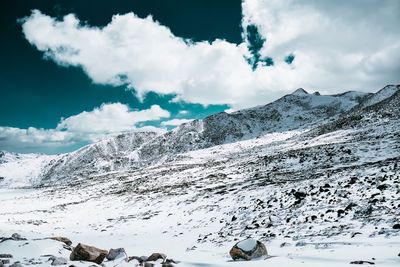 Scenic view of snow covered mountains against sky