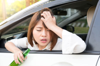 Drunk woman sitting in car