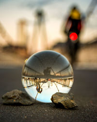 Close-up of crystal ball on bridge with reflection