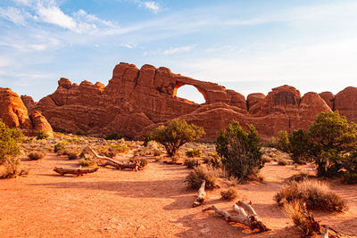 Rock formations on landscape against cloudy sky