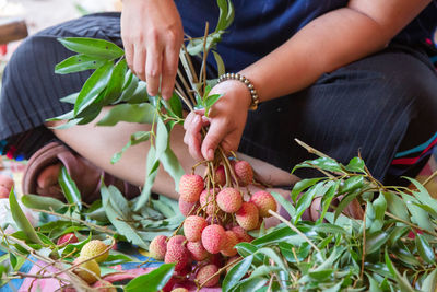 Midsection of woman holding vegetables in basket