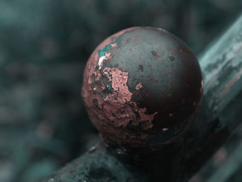 Close-up of apple ball on rusty metal