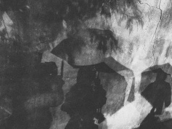 Digital composite image of people shadow on wall