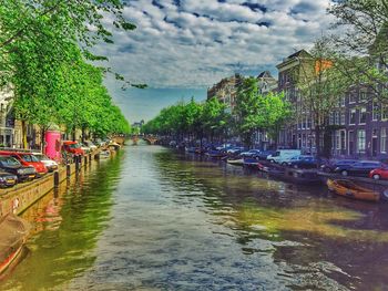 View of canal against cloudy sky