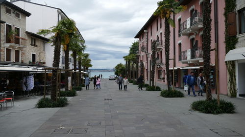 People on street amidst buildings in city