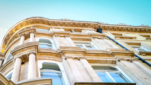 Low angle view of historic building against blue sky