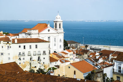 High angle view of church by sea against sky