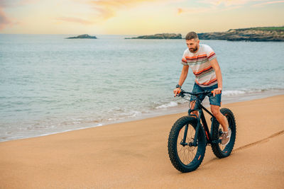 Man riding a fat bike on the beach