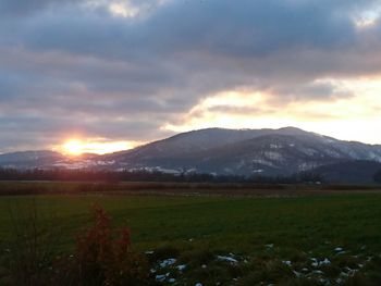 Scenic view of landscape against cloudy sky