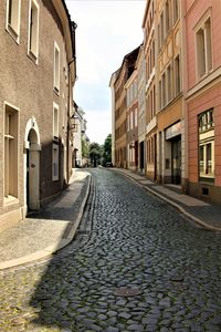 Empty alley amidst buildings in city