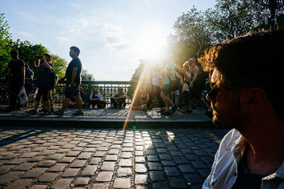 Man standing against people on footpath at admiralbrucke