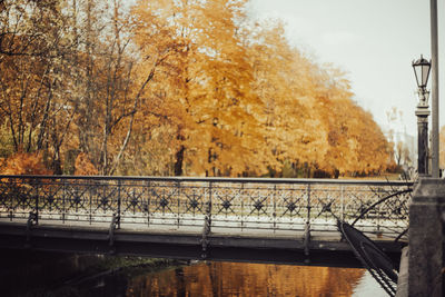 Bridge over river against sky during autumn