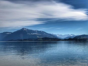 Scenic view of lake and mountains against sky