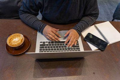 High angle view of man using laptop on table