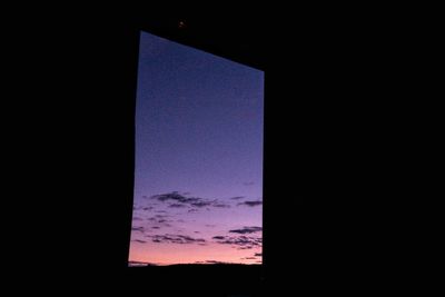 Low angle view of sky seen through silhouette window