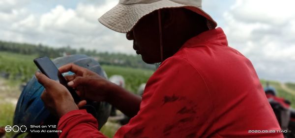 Midsection of man using mobile phone