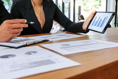 Midsection of woman working on table