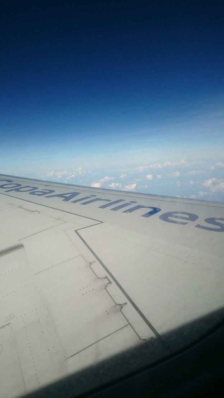 airplane, transportation, sky, blue, flying, scenics, air vehicle, beauty in nature, landscape, copy space, aerial view, nature, tranquil scene, aircraft wing, mode of transport, tranquility, window, clear sky, cropped, travel