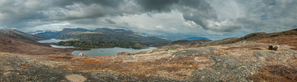 Scenic view of mountains against cloudy sky