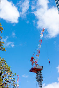 Low angle view of crane against sky