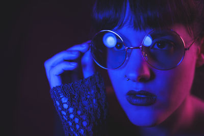 Close-up portrait of young woman wearing eyeglasses