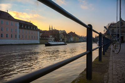 Boats in river with buildings in background