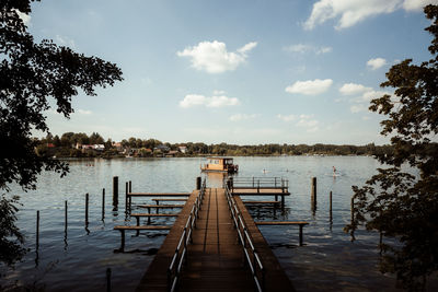 Pier over lake against sky