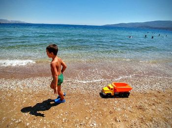 Rear view of man standing on beach