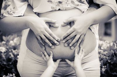 Midsection of woman touching heart