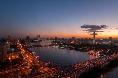 High angle view of city lit up at night