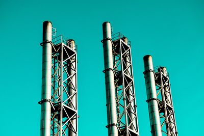 Low angle view of metallic structure against clear blue sky