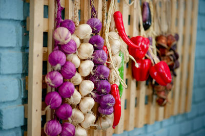 Close-up of various fruits hanging on wood