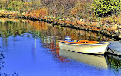 Boats moored in calm lake