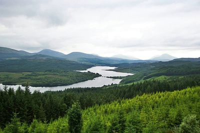 Scenic view of mountains against cloudy sky