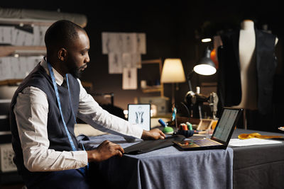 Side view of man working at office