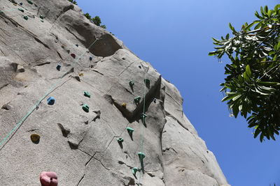 Low angle view of rocks against clear blue sky