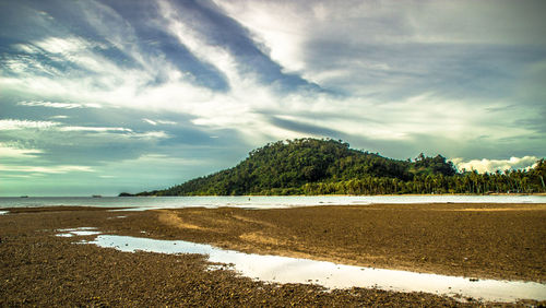 Scenic view of sea against cloudy sky