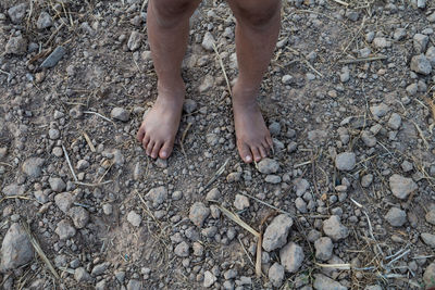 Low section of child standing on ground