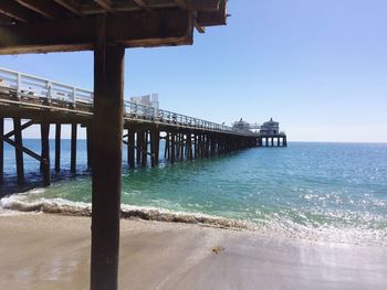 Pier over sea against clear sky