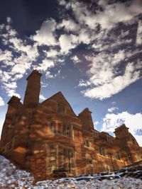 Low angle view of building against cloudy sky