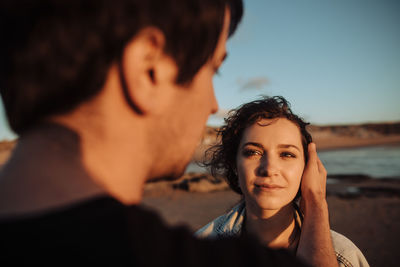 Close up of young woman looking at man standing face to face