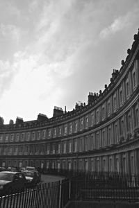 Low angle view of buildings against cloudy sky