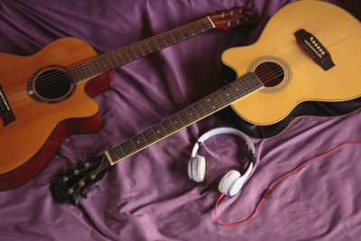 High angle view of guitar playing on bed